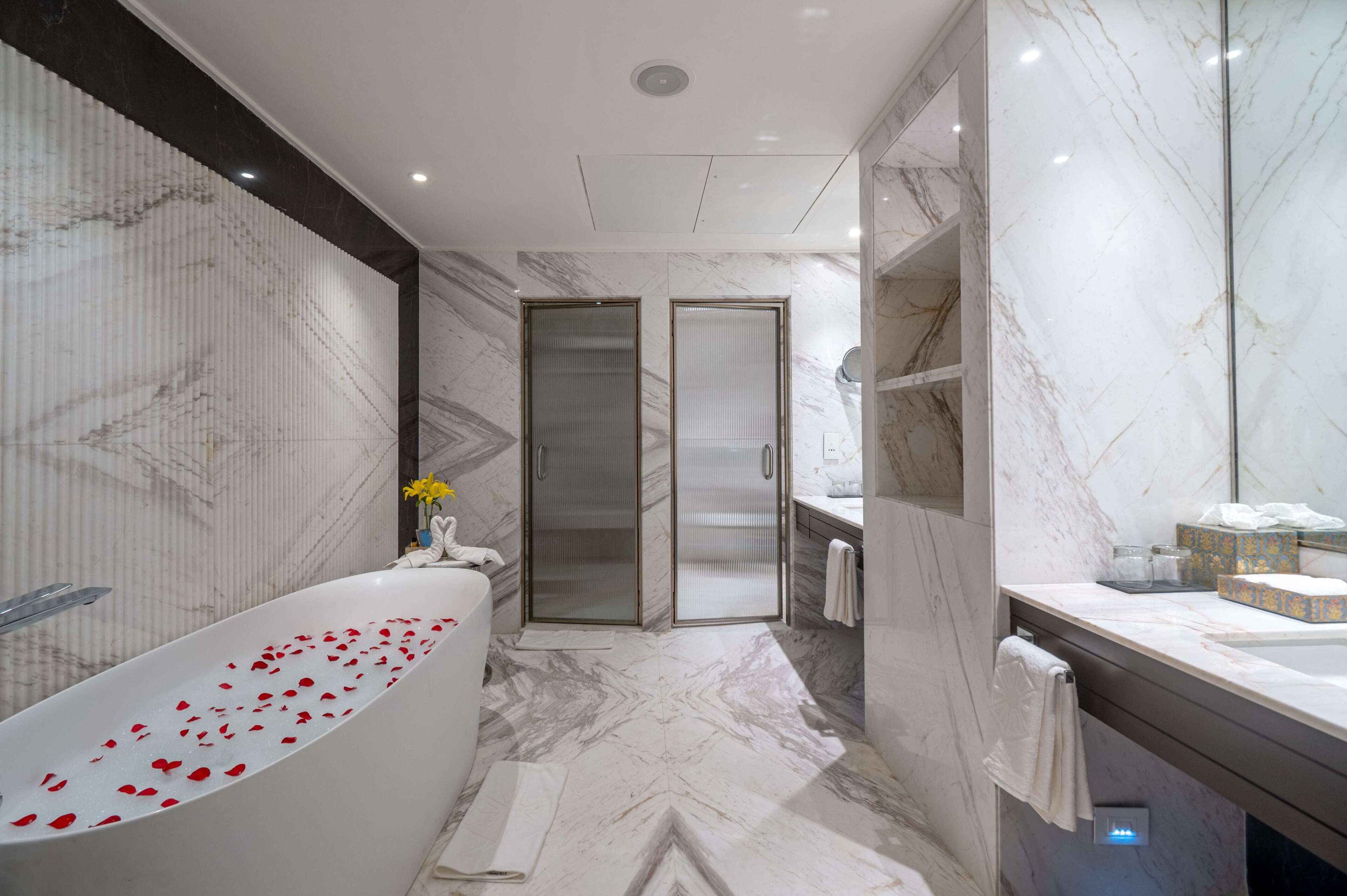 presidential suite, 1 bedroom, garden view | bathroom | combined shower/bathtub, rainfall showerhead, free toiletries