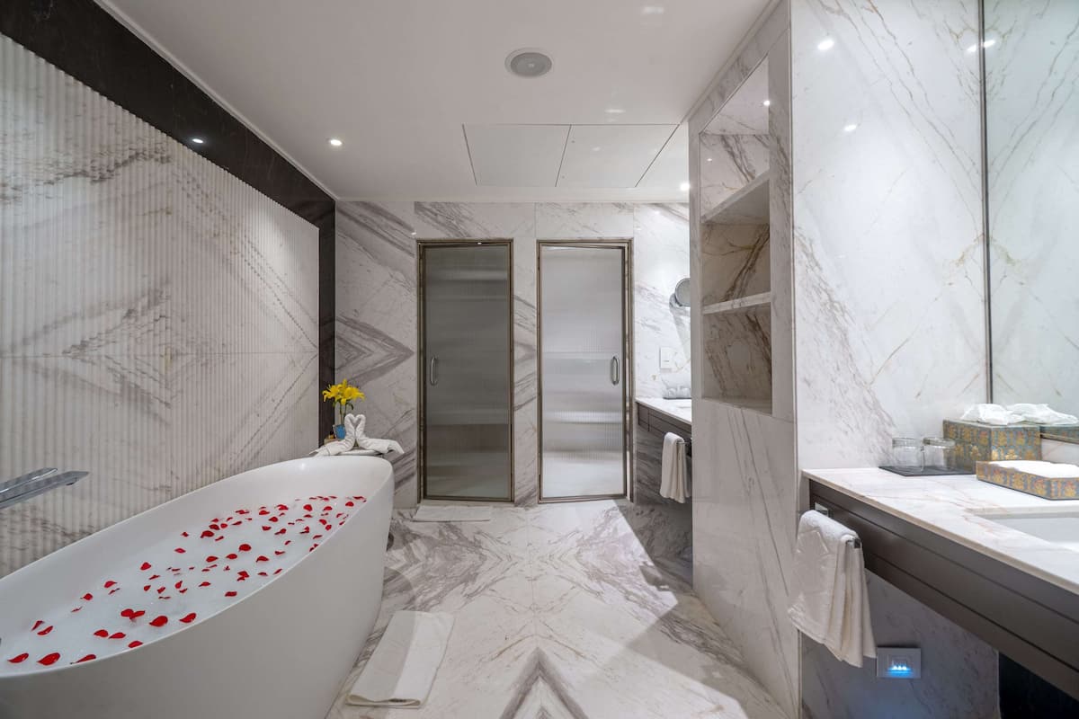 presidential suite, 1 bedroom, garden view | bathroom | combined shower/bathtub, rainfall showerhead, free toiletries