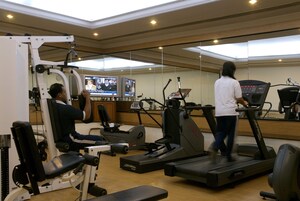 A gym with various exercise equipment, including treadmills and weight machines.