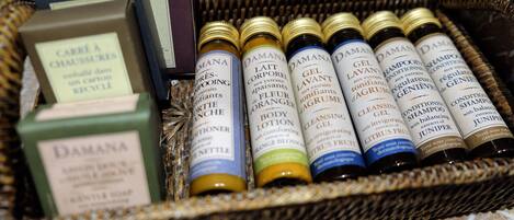 A wicker basket containing various bottles of personal care products, including body lotion and cleansing gel.