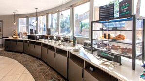 A breakfast bar with a variety of baked goods and a sign indicating fresh baked items. - Holiday Inn & Suites Scottsdale North - Airpark by IHG (Scottsdale)