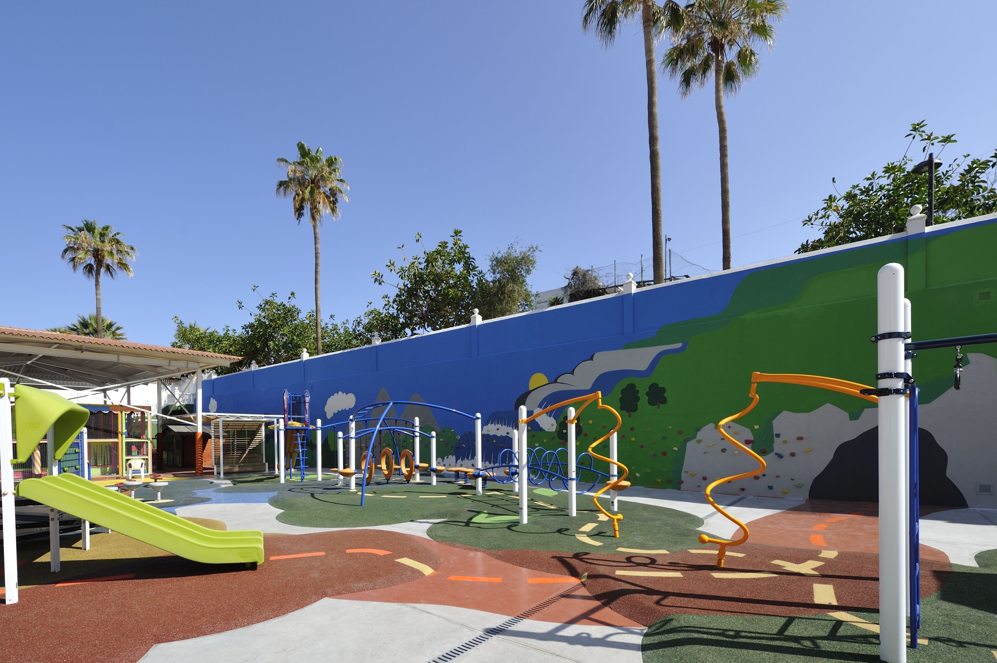 A playground with climbing structures and a slide.