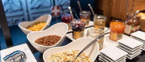 A breakfast buffet with various food items and condiments.