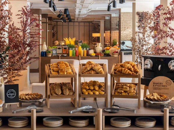 A bakery display with various baked goods and a coffee machine.