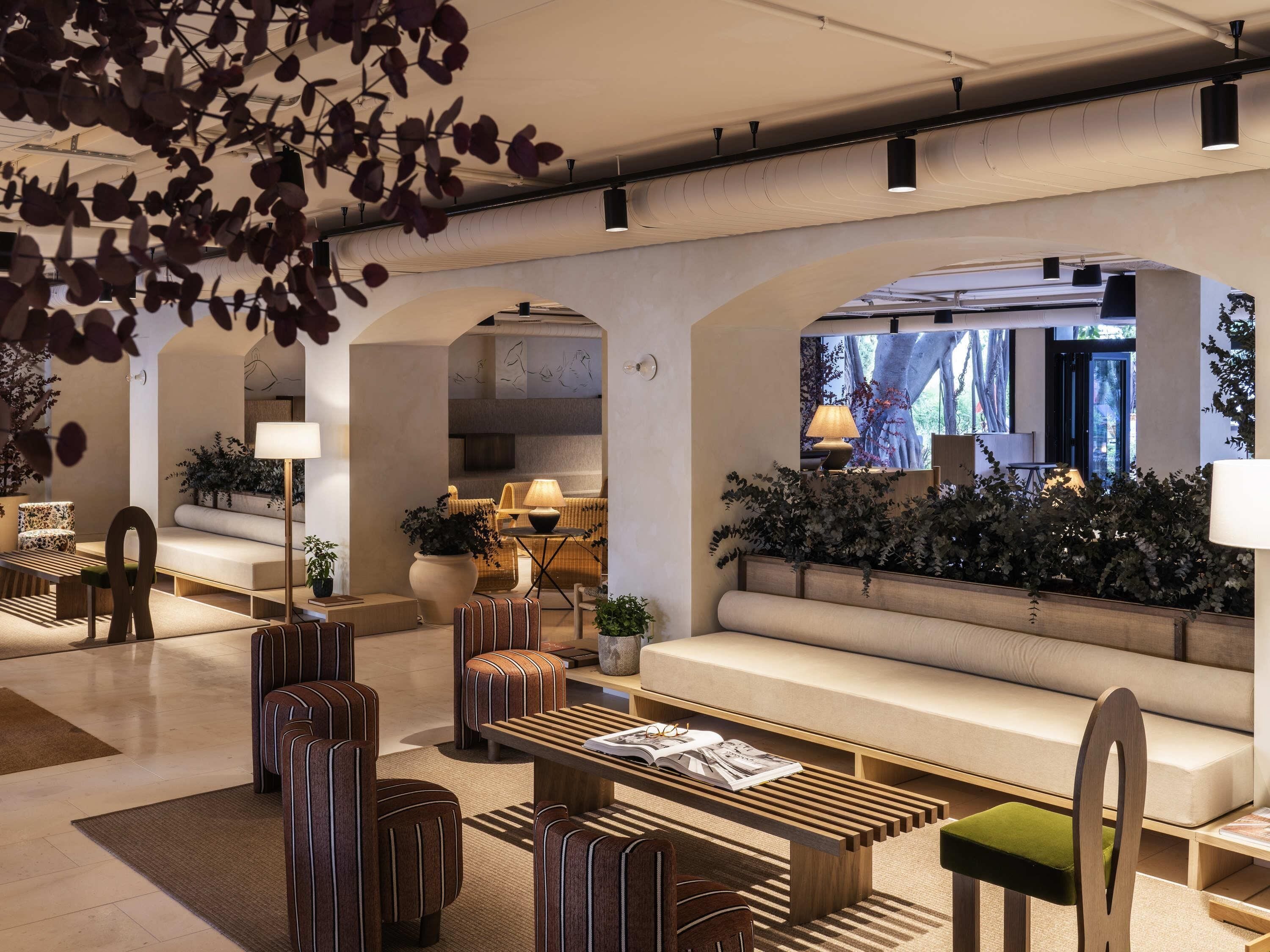 A modern lobby with a seating area, a coffee table, and a sofa.