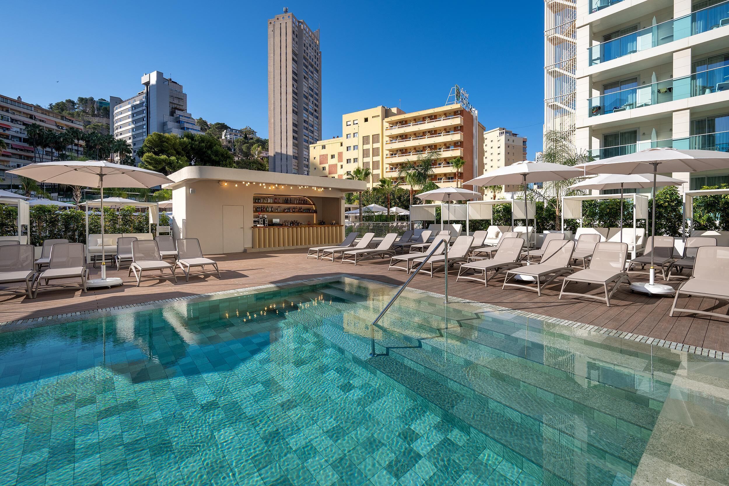 Outdoor pool, open 9:00 AM to 8:00 PM, pool umbrellas, pool loungers