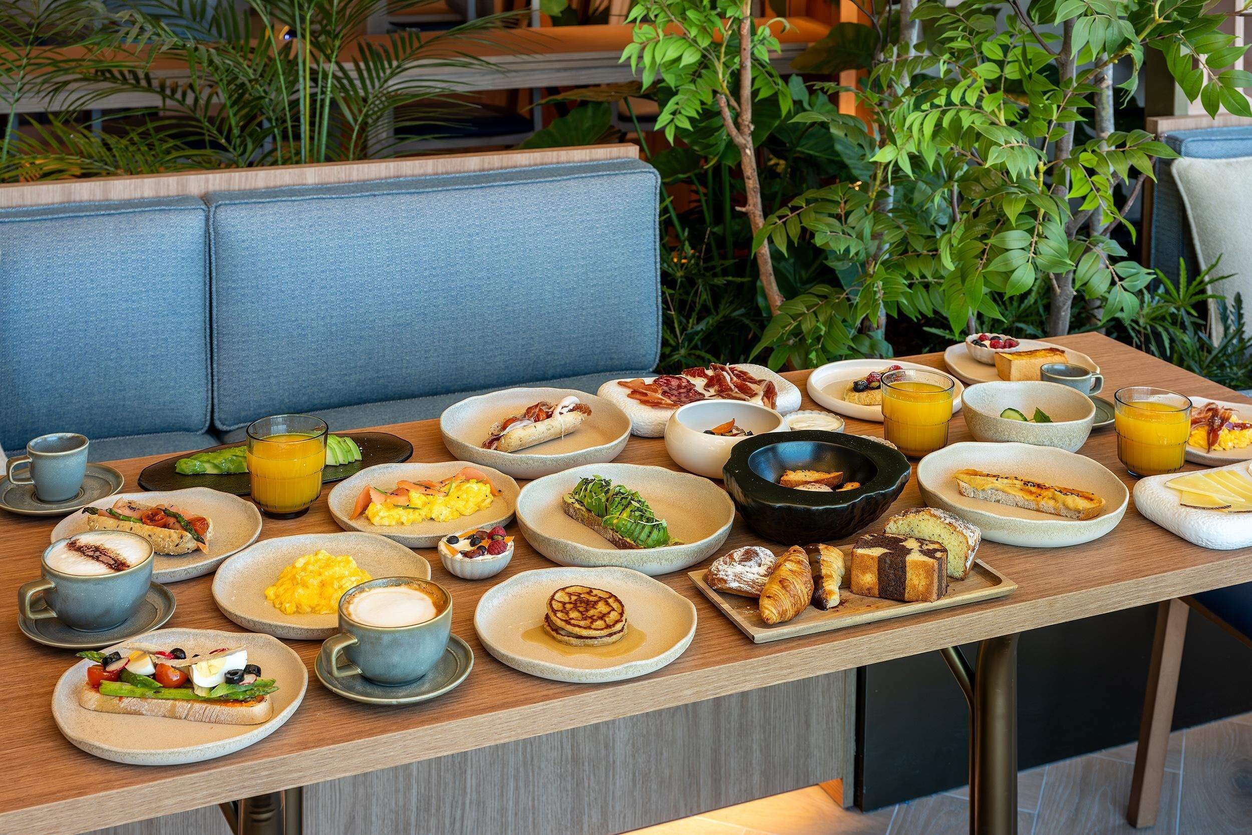 A breakfast buffet with various dishes and beverages.