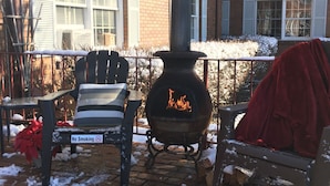 A brick building with a chimney, a bench, and a 'No Smoking' sign. - Colts Neck Inn Hotel (Colts Neck)