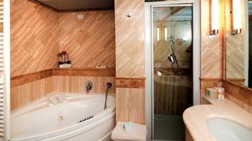 A modern bathroom with a bathtub, shower, and sink.