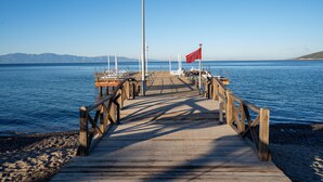 A wooden pier extending into calm water with a clear sky. - Latanya Park Resort - All Inclusive (Bodrum)