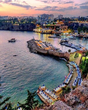 A coastal cityscape with a marina, boats, and a waterfront promenade. - Reutlingenhof Boutique Hotel - Special Class (Antalya)