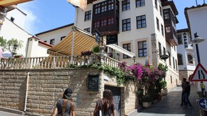 A hotel with a stone facade, balconies, and a sign indicating it is a hotel. - Reutlingenhof Boutique Hotel - Special Class (Antalya)