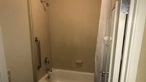 A bathroom with a bathtub, toilet, and shower. - Quality Inn & Suites Ann Arbor Hwy 23 (Ann Arbor)