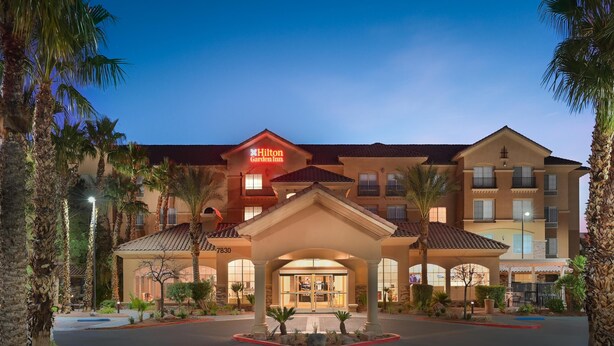 A Hilton Garden Inn with a central entrance, multiple floors, and a well-lit facade. - Hilton Garden Inn Las Vegas Strip South (Las Vegas)