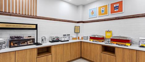A breakfast bar with a sign, a coffee machine, and a sign for eggs.