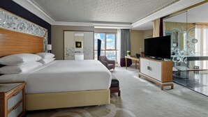 A hotel room with a large bed, a television, a desk, and a view of the city. - InterContinental Cairo Citystars by IHG (Cairo)
