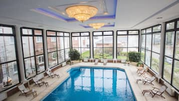 Indoor pool, open 10:00 AM to 10:00 PM, pool loungers