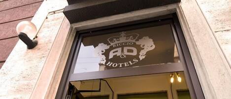 A hotel entrance with a sign reading "Riccio AP Hotels".