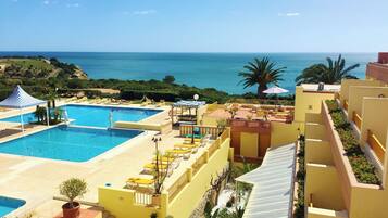 Indoor pool, outdoor pool, pool umbrellas, pool loungers