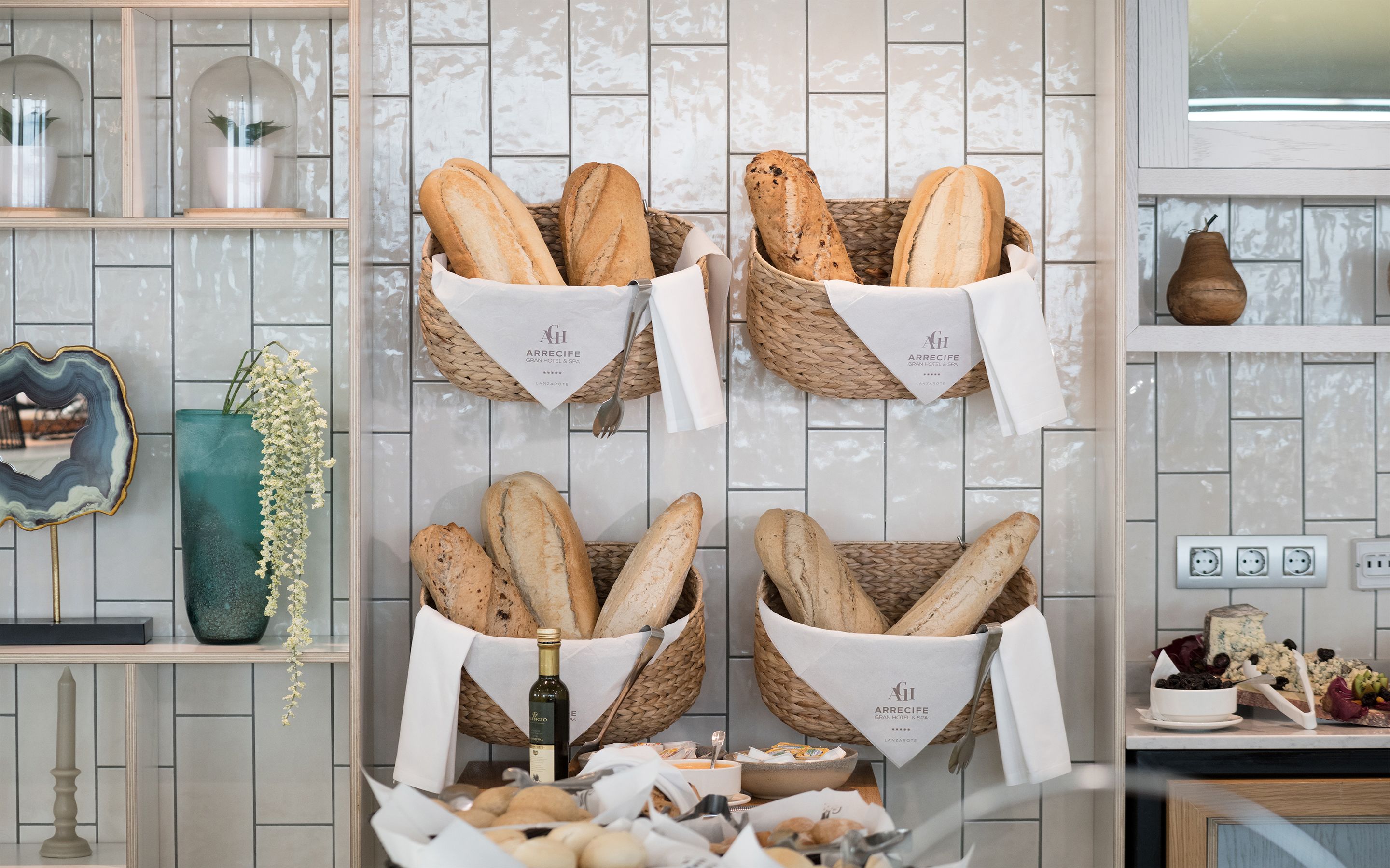 Four baskets of bread on a wall, each with a napkin and a logo.