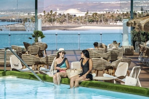 Indoor pool, pool umbrellas, pool loungers