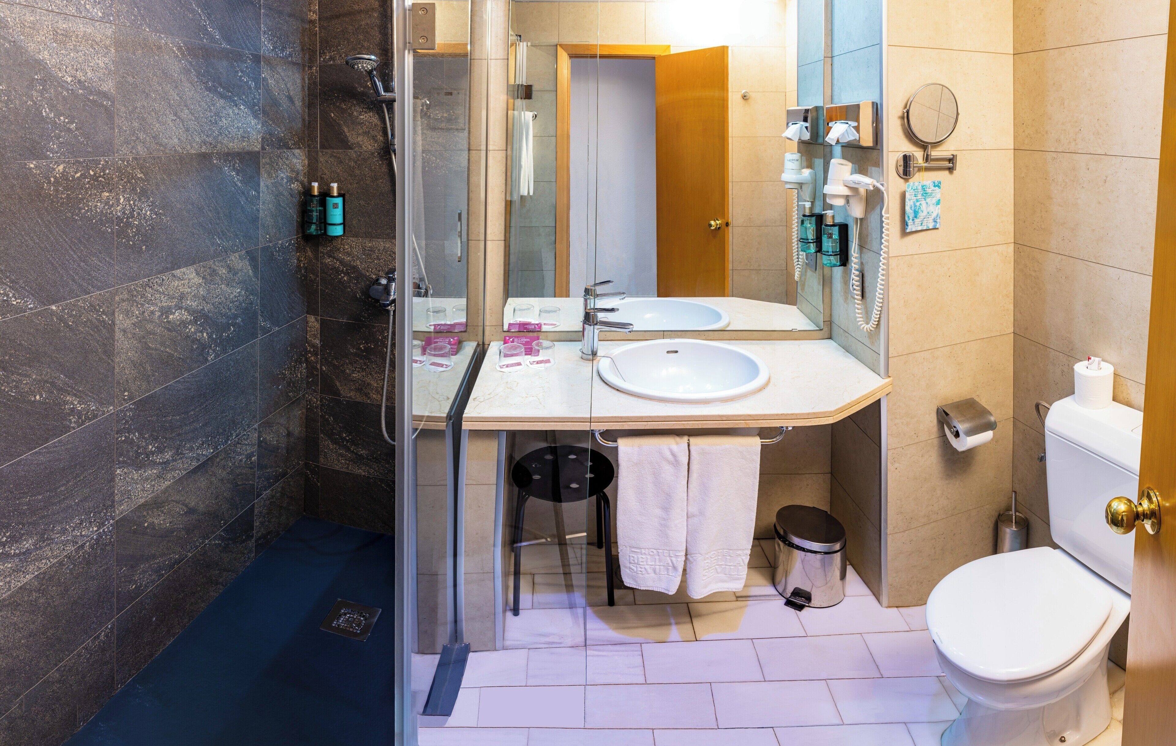 designer toiletries, hair dryer, bidet, towels