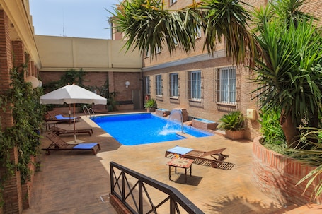 Seasonal outdoor pool, open 10:00 AM to 9:00 PM, pool umbrellas
