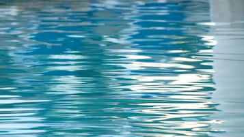Primer plano de una piscina con agua cristalina que refleja la luz.