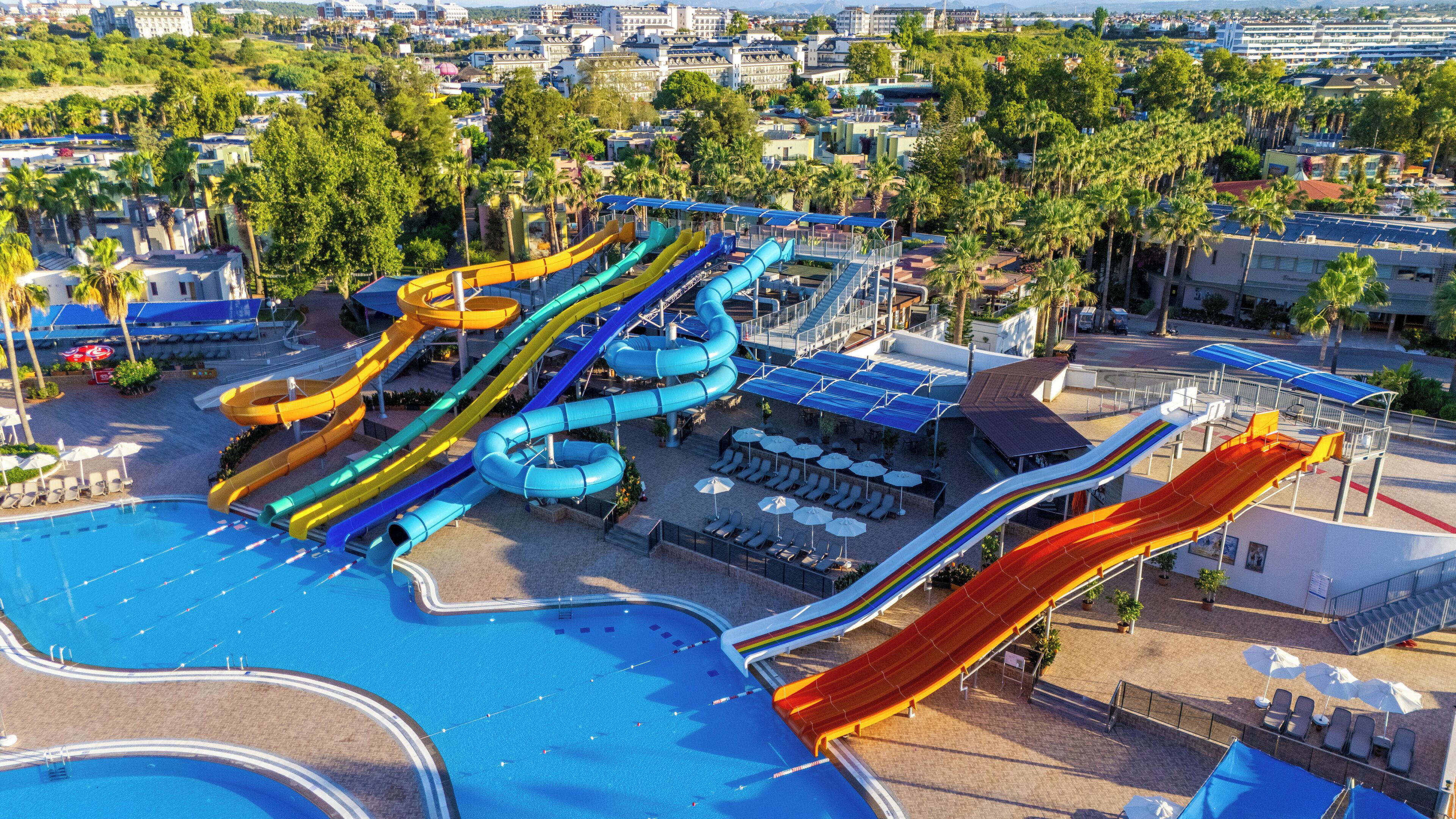 A water park with multiple slides and a swimming pool.