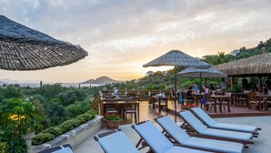 A rooftop terrace with lounge chairs, umbrellas, and dining tables. - 4Reasons Hotel And Bistro | 12+ (Bodrum)