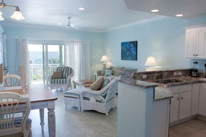 Deluxe Condo, 1 Bedroom, Poolside | Living room | 42-inch flat-screen TV with cable channels, TV, DVD player