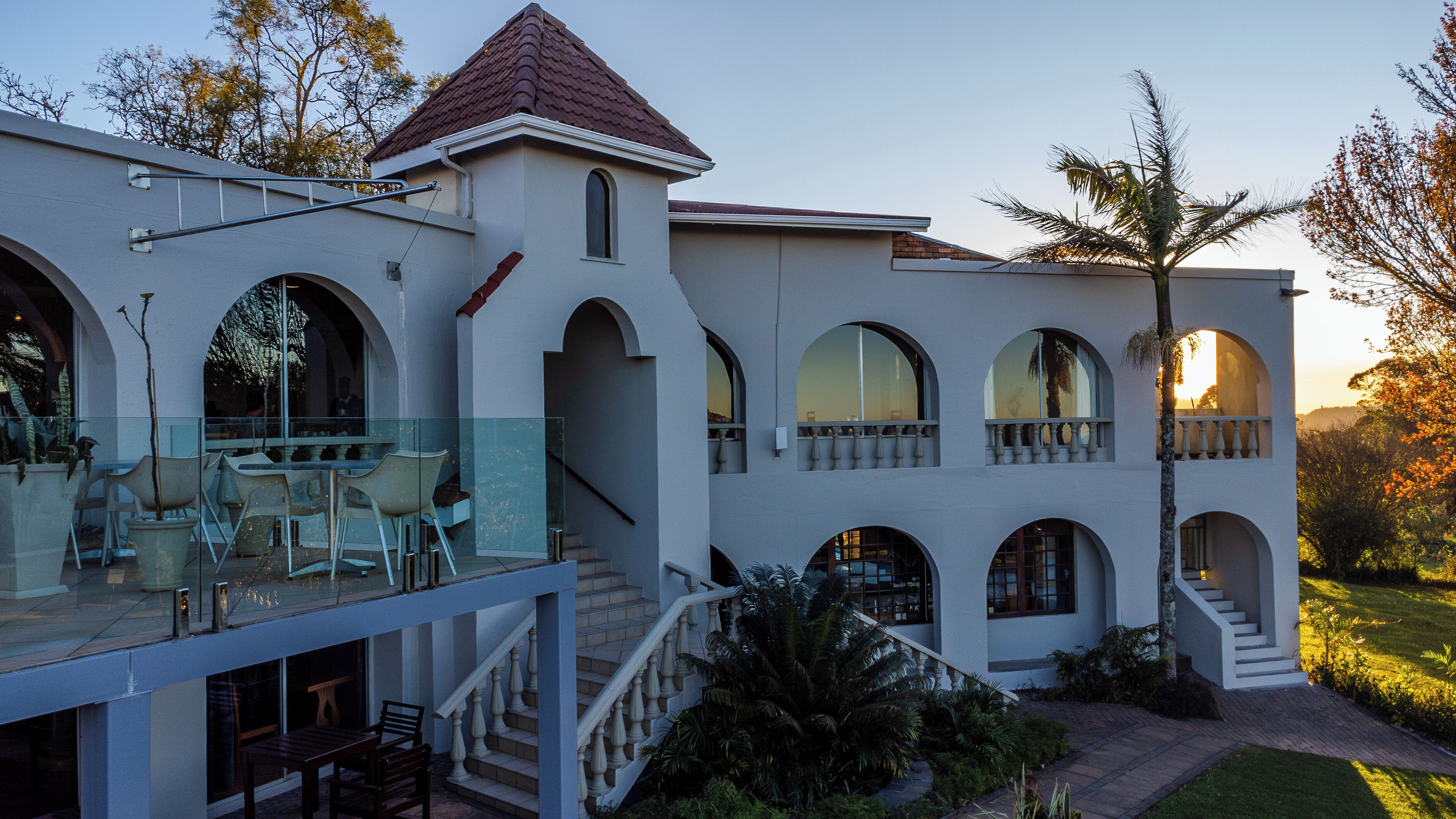 A multi-story building with arched windows and a balcony.