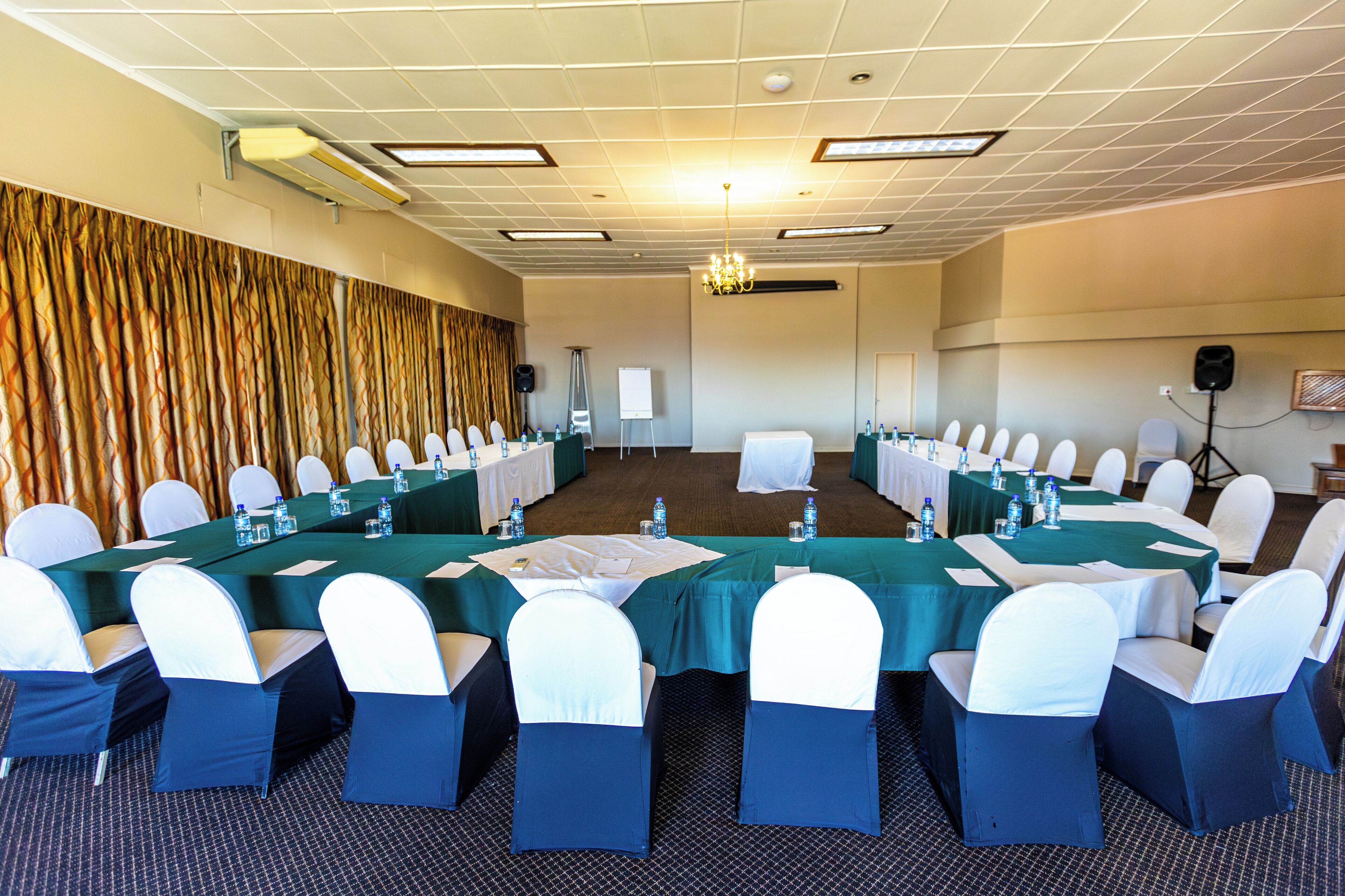 A conference room with a long table, chairs, and a whiteboard.