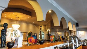 A lobby with arched ceilings, a chandelier, and buffet setup. -  Mountain View International Hotel (Mbabane)