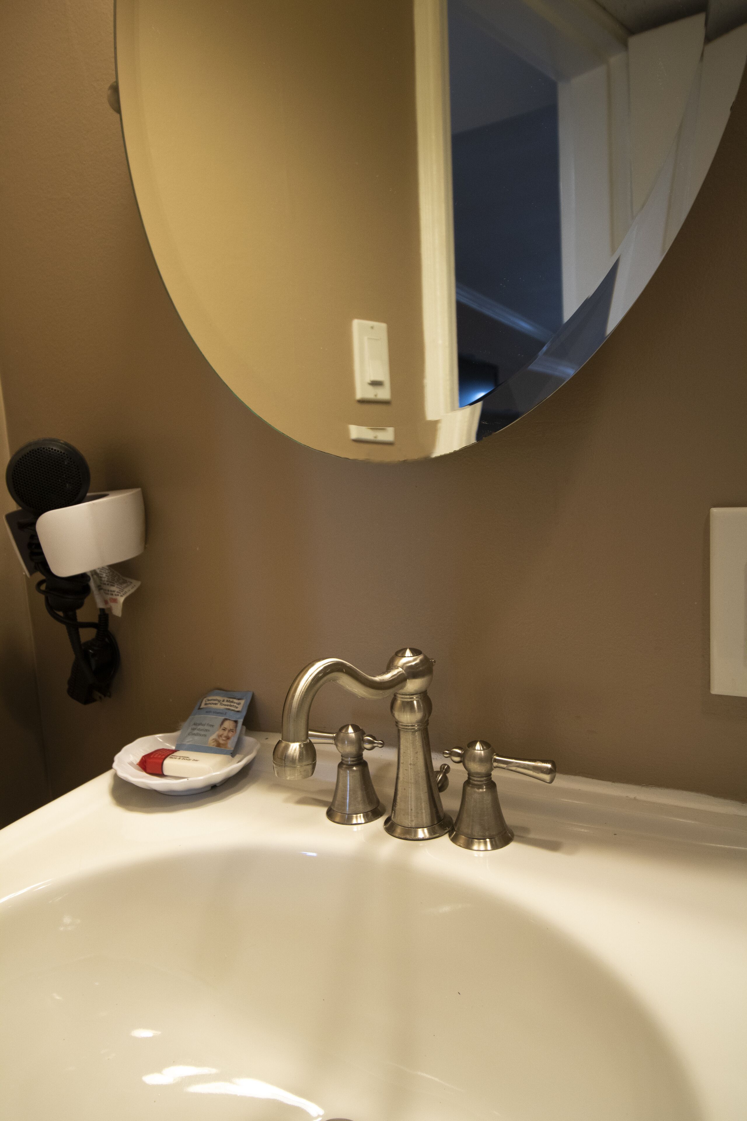 A bathroom sink with a mirror, a faucet, and a soap dish.