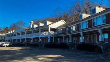 A row of townhouses with a central walkway and a parking area.