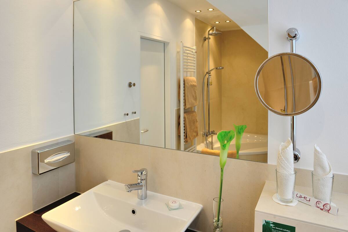 classic studio suite | bathroom | slippers, towels