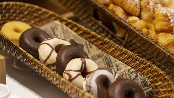 A wicker basket filled with donuts and pastries.