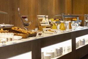 Enjoy a diverse spread of international cuisine at our buffet, featuring a variety of dishes and refreshing beverages.