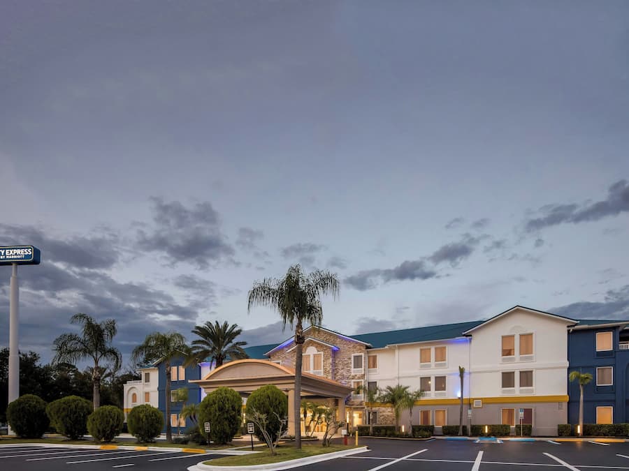 A hotel with a modern design, featuring a central courtyard and multiple buildings.