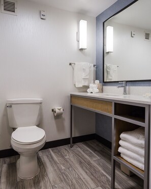 A modern bathroom with a toilet, sink, and mirror. - Hilton Garden Inn Atlanta Marietta (Atlanta)