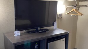 A minibar with a television, a mini-fridge, and a microwave. - Super 8 by Wyndham Independence KS (Independence)