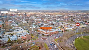 An aerial view of a town with landmarks like Ballarat Base Hospital, St John of God Hospital, and The Western Hotel.