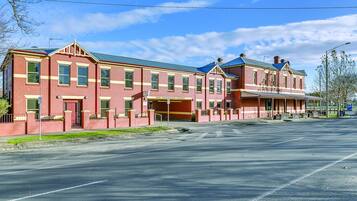A large brick building with a flat roof and a central entrance.