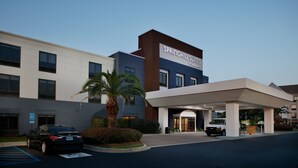 A hotel with a modern facade, a covered entrance, and a parking area. - SpringHill Suites by Marriott Savannah Airport (Savannah)