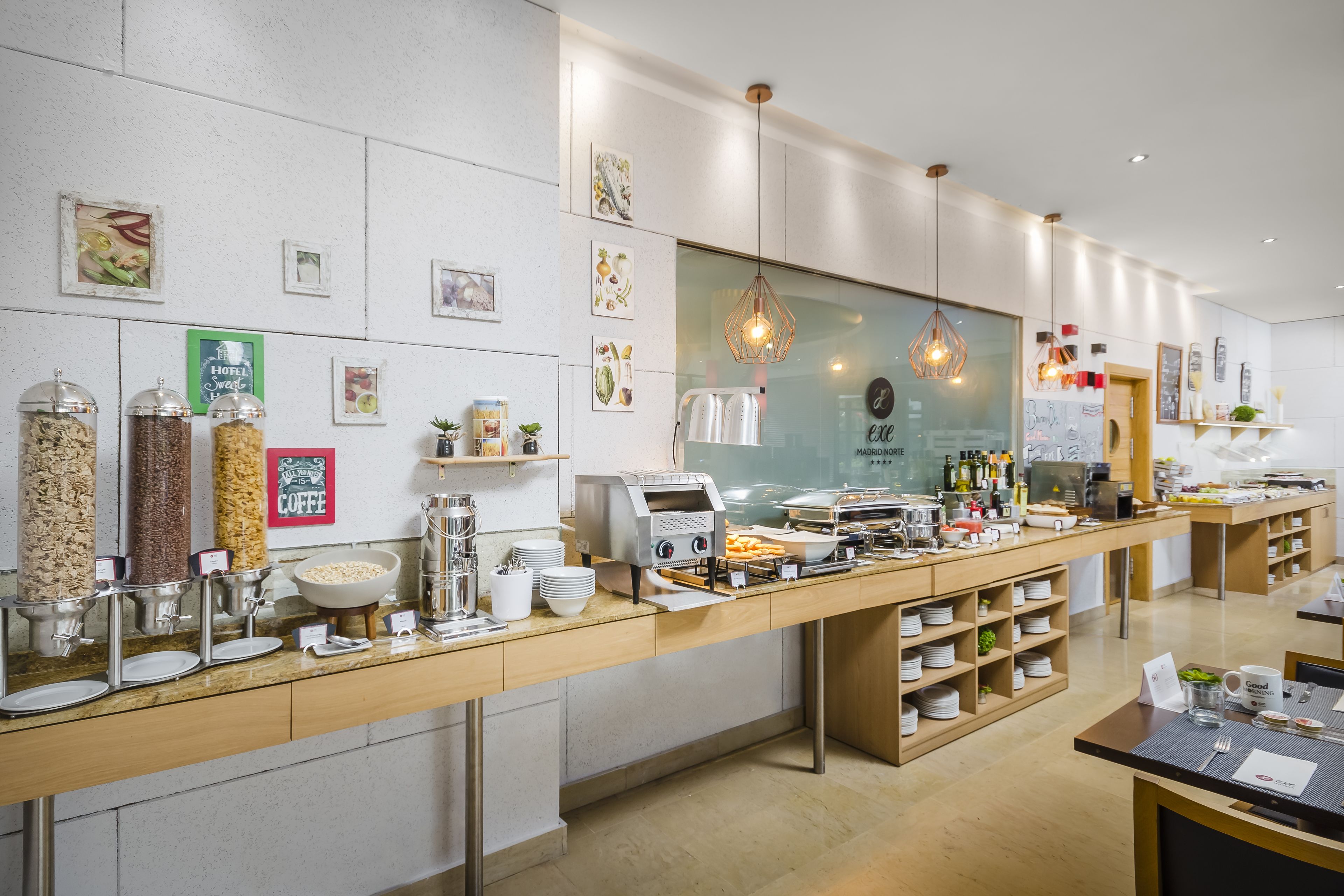 A hotel breakfast buffet with various food items, a coffee station, and a modern interior design.