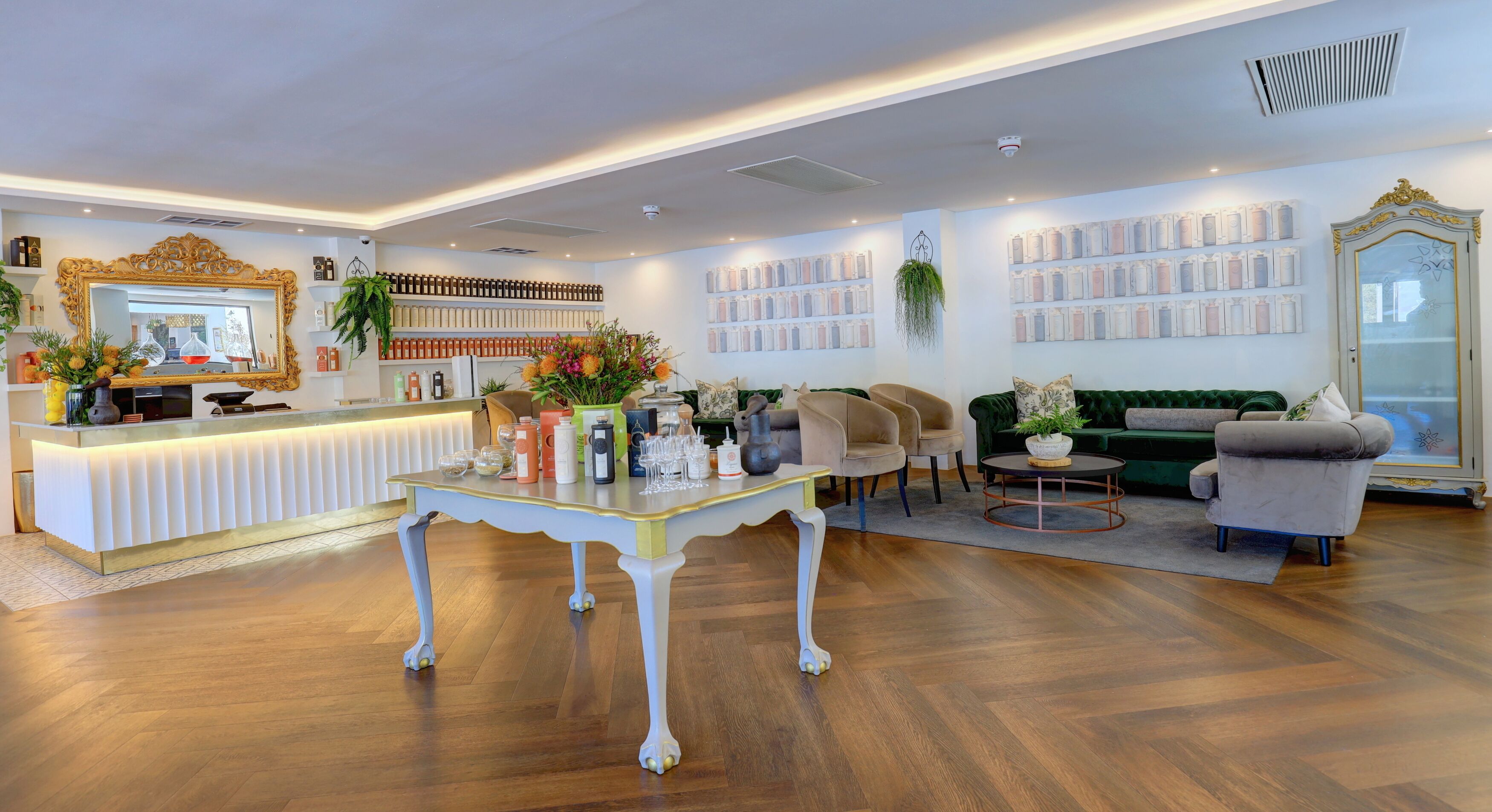 A modern hotel lobby with a reception desk, seating area, and decorative elements.