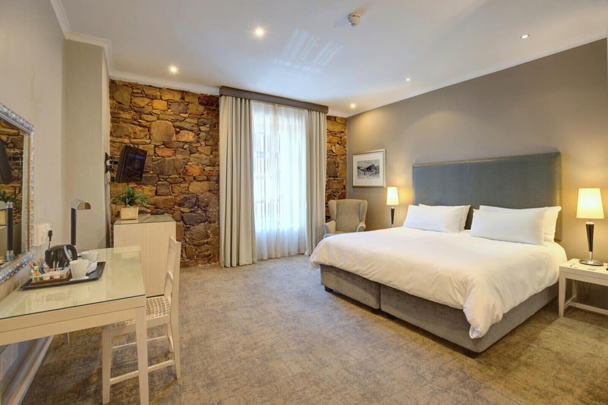Deluxe Room, 1 King Bed, Non Smoking | 1 bedroom, down comforters, in-room safe, individually decorated