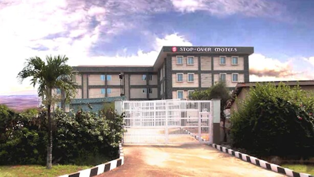 A multi-story building with a sign reading "STOP-OVER MOTELS". - Stop Over Motels (Lagos)