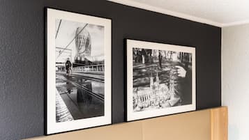 Two black and white photographs framed and hung on a wall.